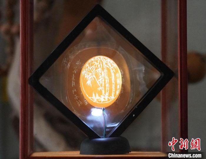 圖為吳義澤新包裝給蛋雕呈現(xiàn)立體感?！【琶赖ぴ?攝